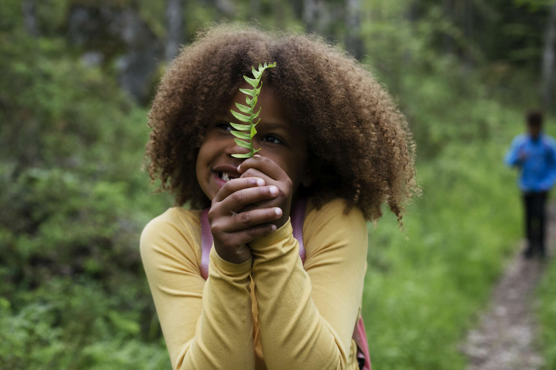 Girl holding a green leaf