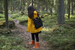 Nainen kävelee metsäpolulla